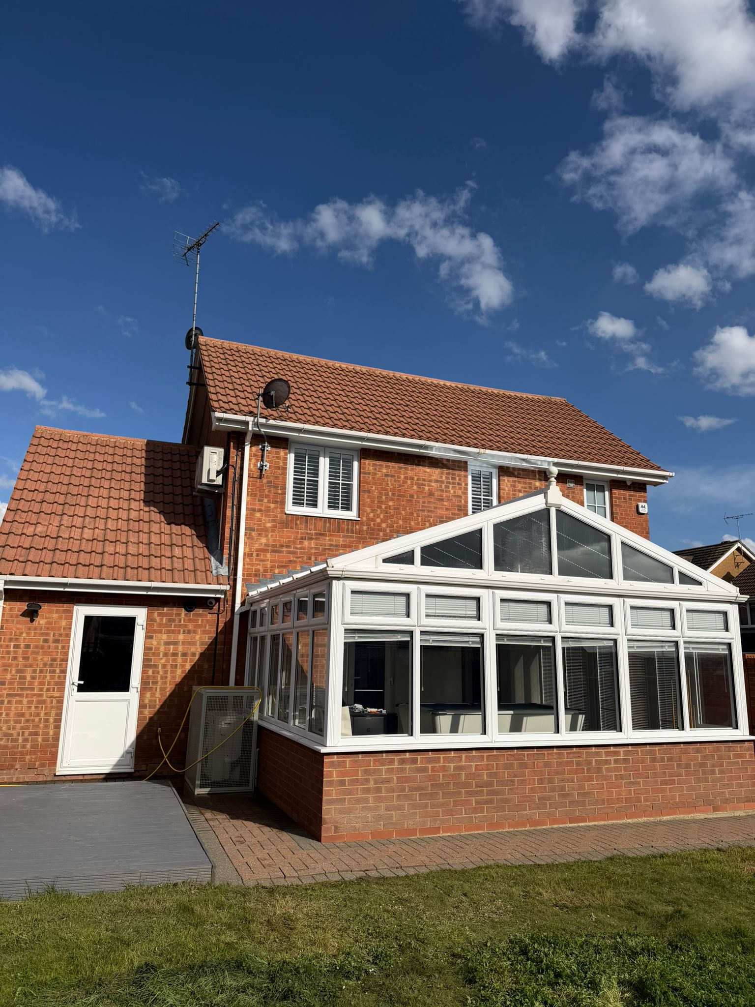 Freshly cleaned terracotta roof tiles on an Essex detached house. Pure Shine Exterior Cleaning